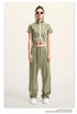 Light green mock neck crop top with front zip and white sleeve stripes, front view