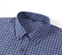 Close-up of blue check shirt collar showing button-down detail and brand label placement