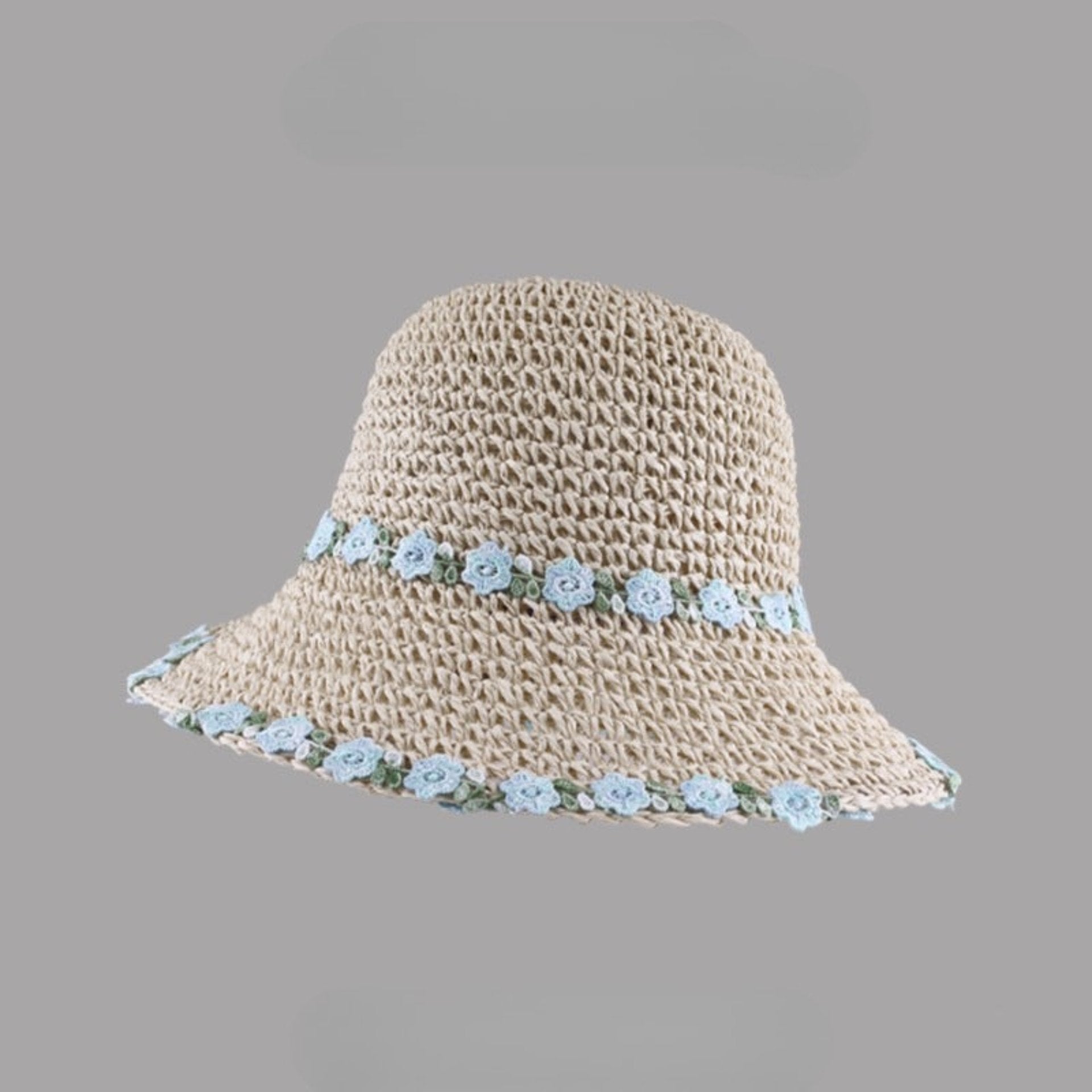 Beige woven straw hat with a wide brim, featuring blue floral embroidery along the brim and crown, displayed on a gray background.