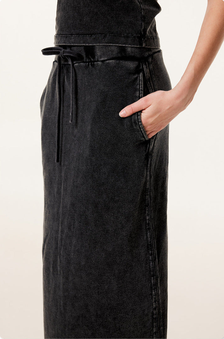 Close-up of black long denim skirt with side pocket and visible side seam stitching