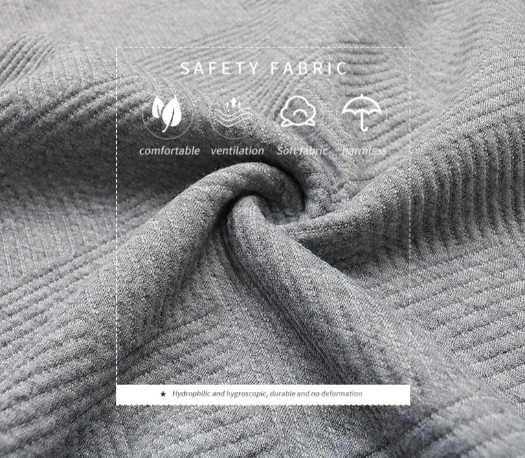 Close-up of gray textured fabric showing safety features: comfortable, ventilation, soft fabric and harmless properties