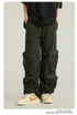 Close-up of olive green cargo pants with attached zippered utility pockets shown with black oversized top and cream sneakers