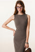 Detailed view of brown sleeveless bodycon maxi dress, styled with a heart pendant necklace and tortoise-shell glasses.