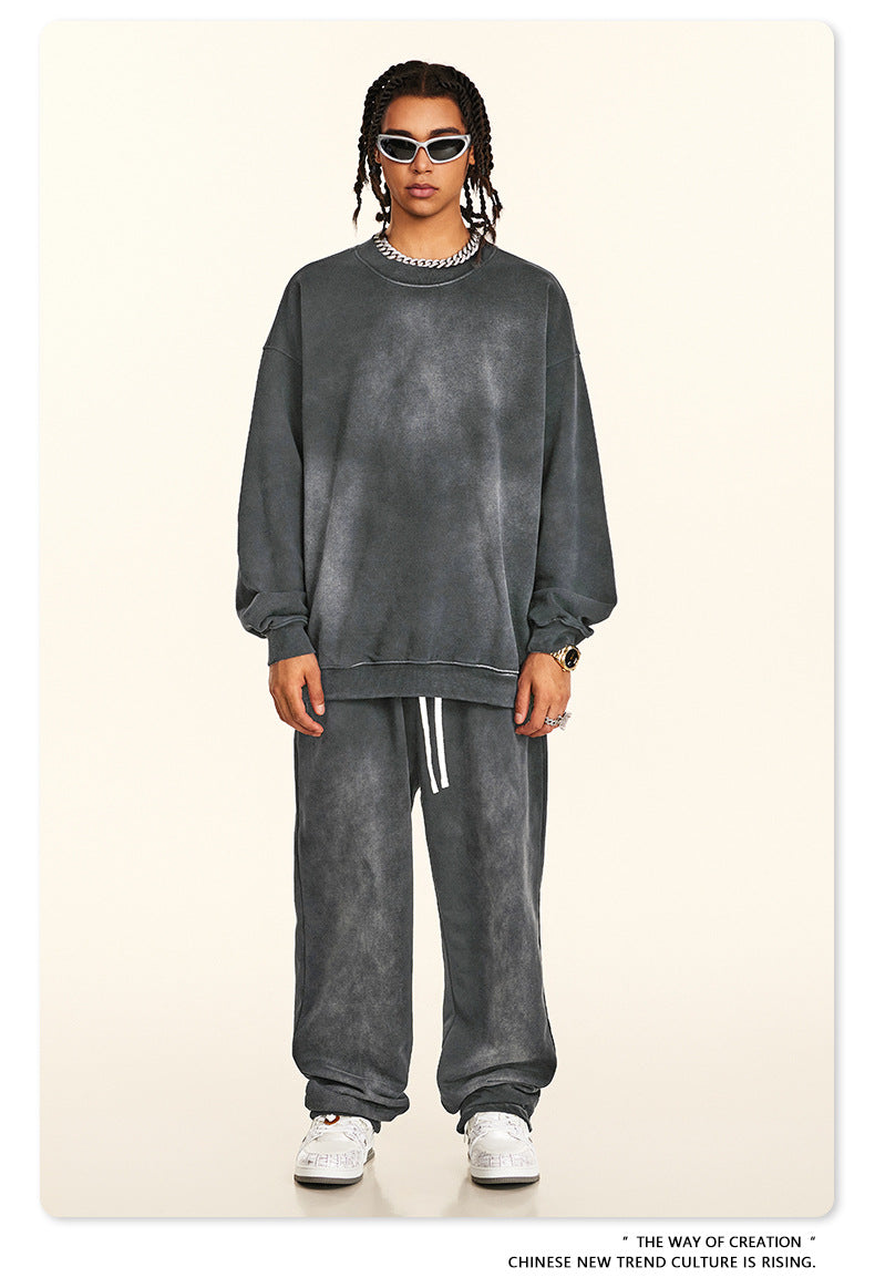 Street style grey sweatsuit with white drawstrings, styled with retro sunglasses and chunky sneakers