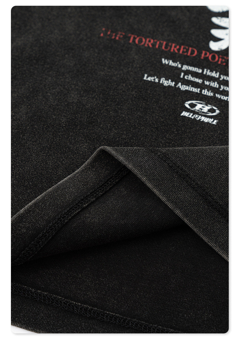Close-up of the soft, textured black fabric with visible stitching, highlighting the T-shirt’s quality material
