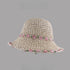 Beige woven straw hat with pink floral embroidery along the brim and band, displayed on a gray background.