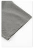 Close-up of fabric texture and stitch detail on gray cotton t-shirt hem