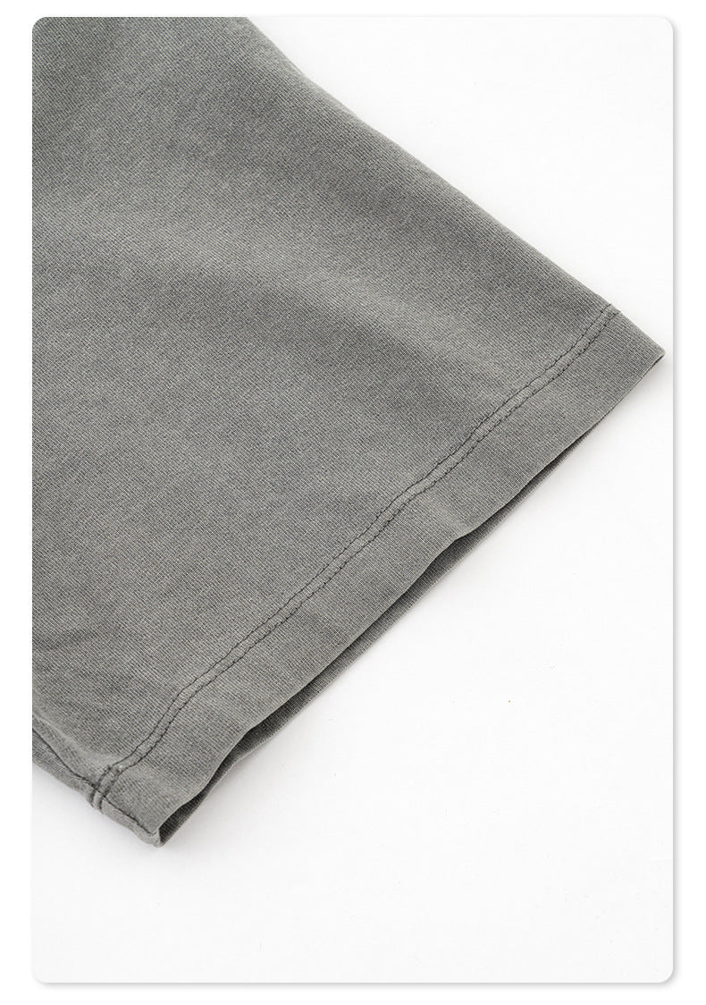 Close-up of fabric texture and stitch detail on gray cotton t-shirt hem