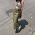 Olive green cargo maxi skirt with side lace-up details, shown with graphic tank top and fringe crossbody bag