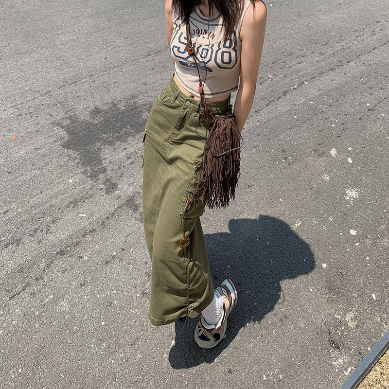 Olive green cargo maxi skirt with side lace-up details, shown with graphic tank top and fringe crossbody bag