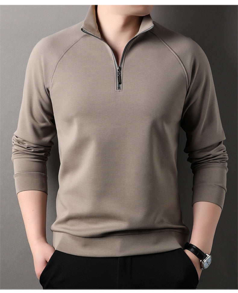 Taupe quarter-zip pullover sweater with standing collar and raglan sleeves, worn with black pants and wristwatch