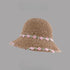 Khaki woven straw hat with pink floral embroidery along the brim and band, displayed on a gray background.