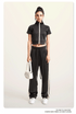 Black cropped jacket and wide-leg pants set with white sneakers