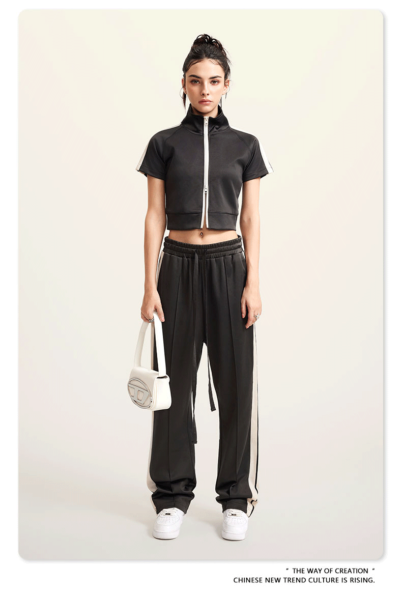 Black cropped jacket and wide-leg pants set with white sneakers