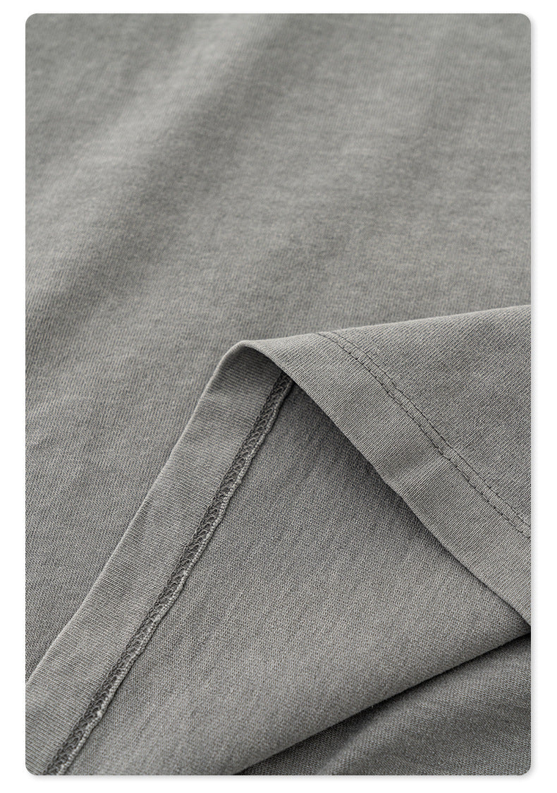 Texture detail showing soft washed cotton fabric of gray t-shirt with visible weave pattern