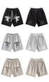 Product layout showing cupid graphic shorts in black, gray and beige colorways with front and back views