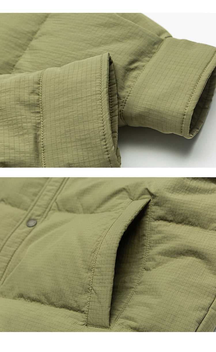 Close-up of olive green ASTROSMASH puffer jacket showing ripstop fabric texture, sleeve cuff and pocket detail