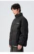 Male model demonstrating brown and black puffer jackets with various styling