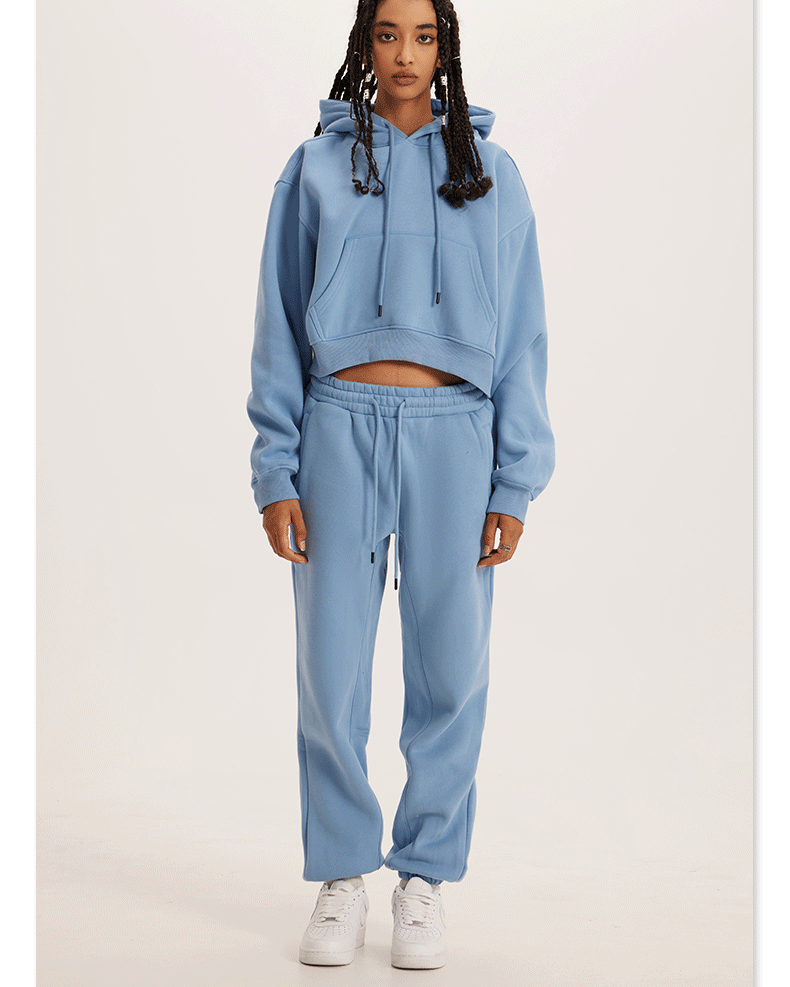 Sky Blue Sweatshirt and Joggers Set – Model in a pastel blue hoodie and joggers, styled with white sneakers