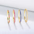 Collection of 14k gold stackable rings featuring multicolor, pink, blue and light blue zircon eternity bands