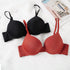 Classic black and terracotta red push-up bras with adjustable straps and smooth cups on white background