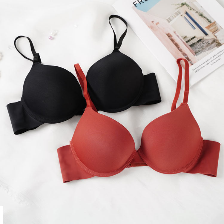 Classic black and terracotta red push-up bras with adjustable straps and smooth cups on white background