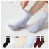Light gray cozy crew socks with white stripes, shown with stretchy fluffy texture. Collection of nine pastel and neutral colored socks displayed below