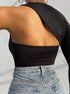 Close-up of a woman's back in a black one-shoulder bodysuit with a cut-out detail, paired with high-waisted jeans.