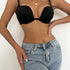 Black push-up plunge bra with adjustable straps worn with light wash high-waisted jeans, showcasing smooth seamless comfort fit