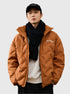 Young man wearing camel brown Aesthetic quilted puffer jacket styled with black scarf and Brooklyn baseball cap against white backdrop