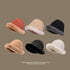 Six faux fur bucket hats in different colors, arranged in two rows - terracotta, beige, black, camel, black, white, all with plush trim, taupe background