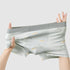 Light gray men's underwear with stretch test demonstration showing elastic fabric quality
