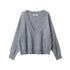 Front view of grey V-neck sweater with ribbed collar detail, distressed trim edges, and drop shoulder design