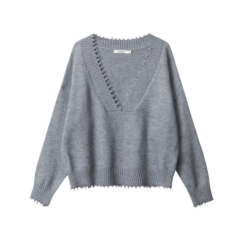 Front view of grey V-neck sweater with ribbed collar detail, distressed trim edges, and drop shoulder design