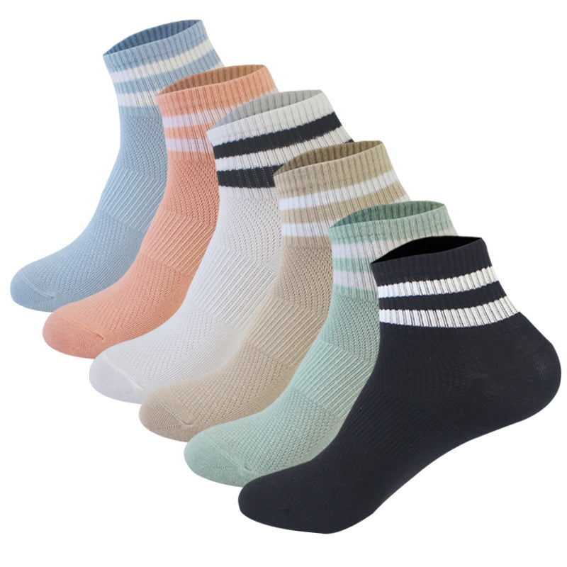 Collection of six ankle socks in pastel colors with white stripes including blue, peach, white, beige, mint green, and black
