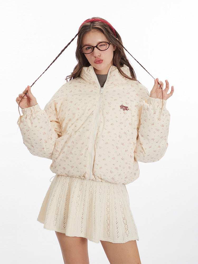 Woman wearing a cream floral puffer jacket with three alternative color options displayed on the right: beige, black, and blue