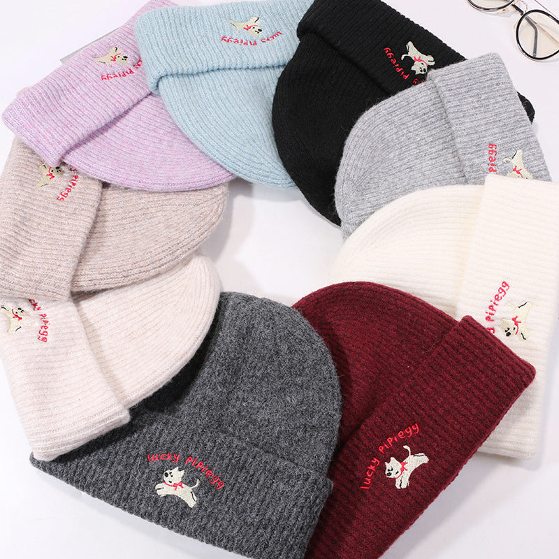 Collection of Lucky Pipiegg beanies in multiple colors including lilac, blue, black, gray, white, and burgundy