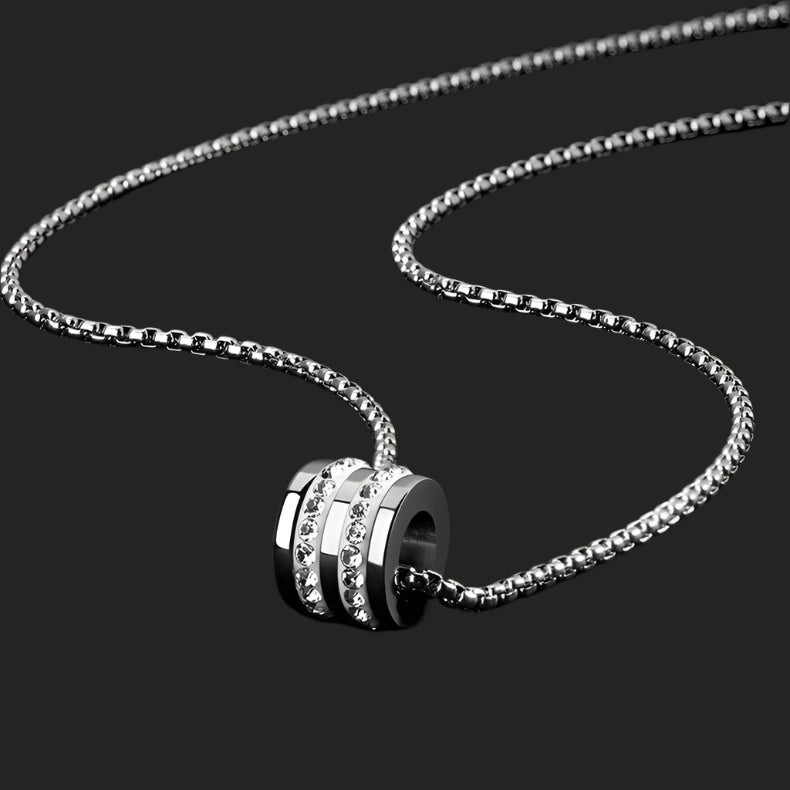 Silver chain necklace with cylindrical pendant featuring crystal bands