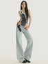Front view, full-body shot: Light wash wide-leg jeans with low-rise waist and relaxed Y2K fit.