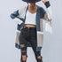 Casual outfit with colorblock cardigan, white crop top, ripped black jeans, and white woven handbag