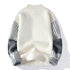 White mockneck sweater with striped sleeves and gray accents, back view
