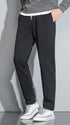 Black slim-fit pants with white drawstring and white-tipped sneakers
