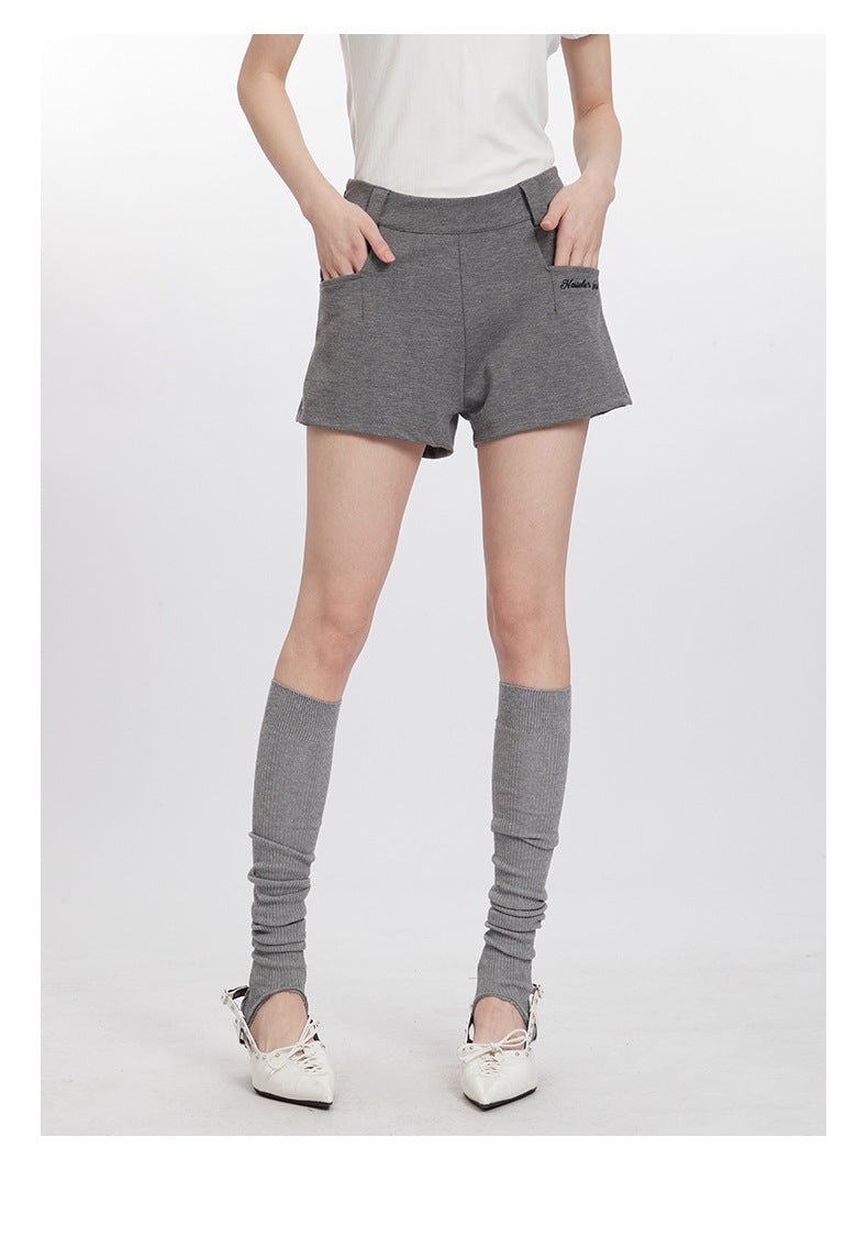 Gray shorts with Haidler Girl logo pocket detail, styled with gray socks and white slingback pumps