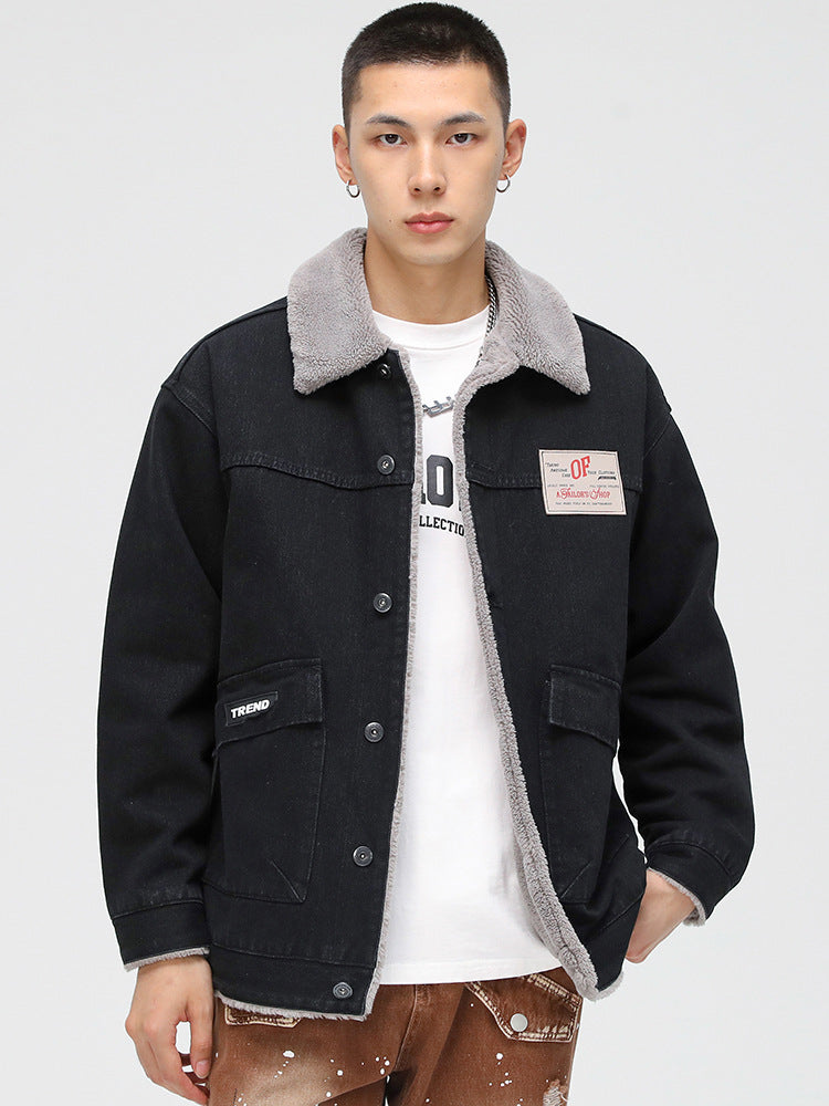 Model wearing black denim jacket with gray sherpa collar, white t-shirt and distressed brown pants. Features OP patch logo
