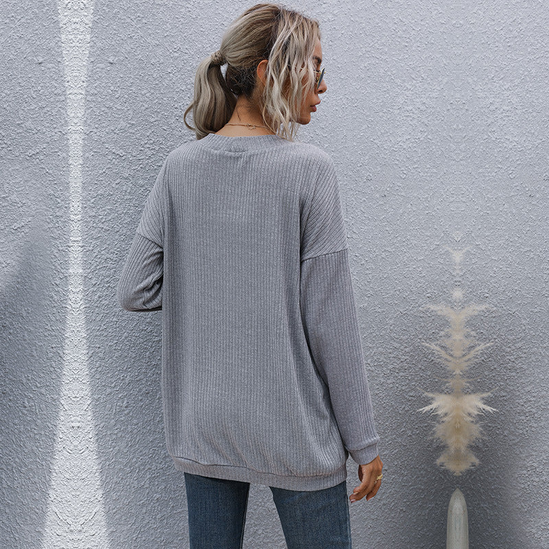 Back view of grey ribbed cardigan, showcasing relaxed fit and textured knit design