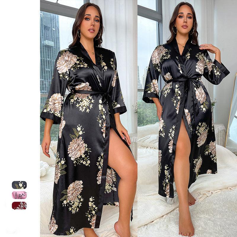 Black and beige floral satin long robe with wide sleeves, worn with a city skyline in the background, showing a side view