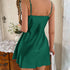 Back view of a woman in a green satin slip dress with adjustable straps