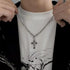 Silver chain necklace with rhinestone-studded cross pendant