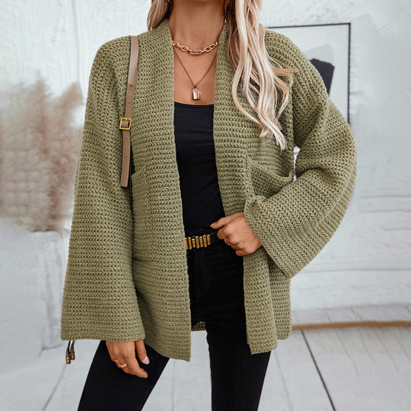 Olive green chunky knit cardigan with bell sleeves and open front, styled with black tank top and gold chain necklaces