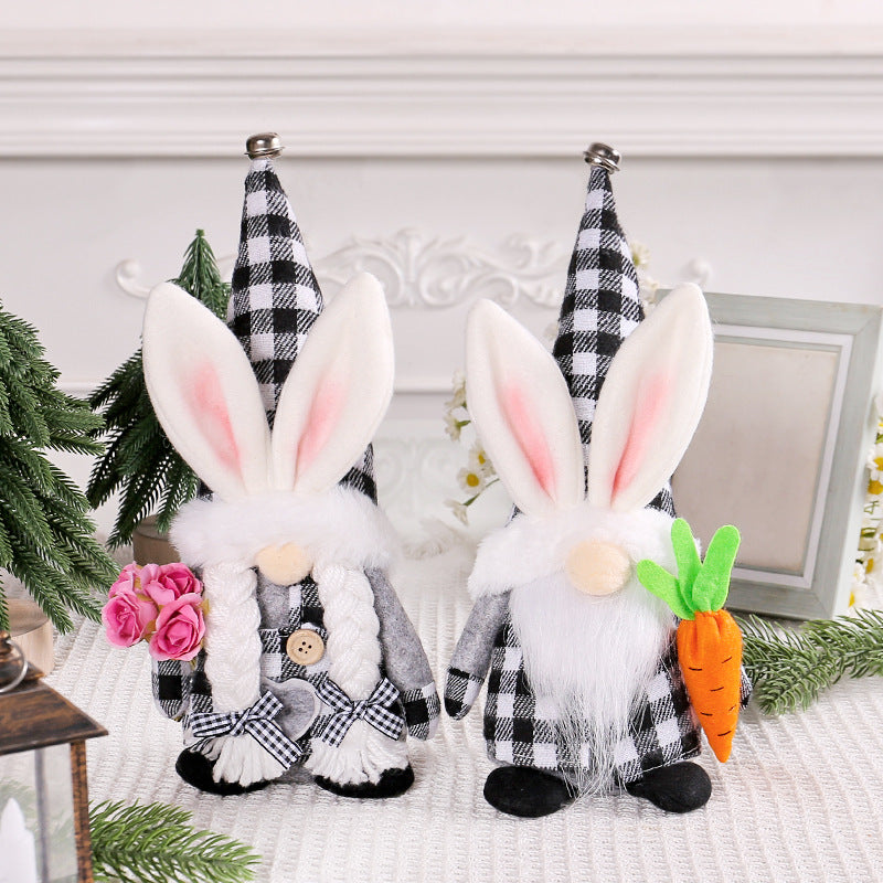 Two Easter gnome plush decorations with bunny ears and black-and-white plaid hats, one holding pink roses and the other a plush carrot.
